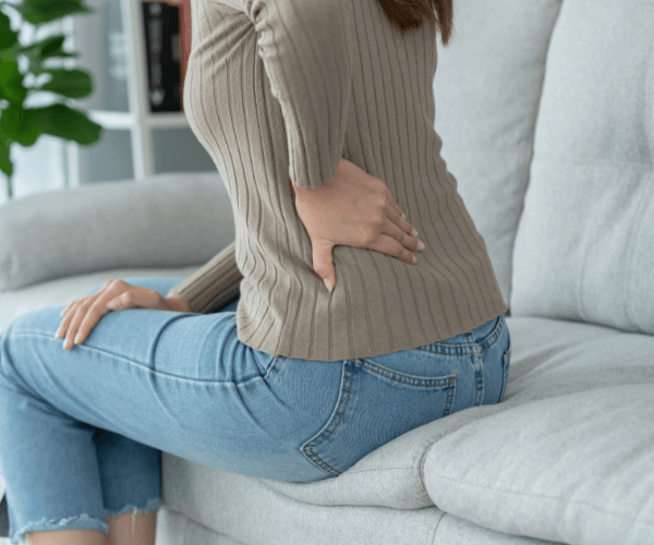 lady on sofa with back pain