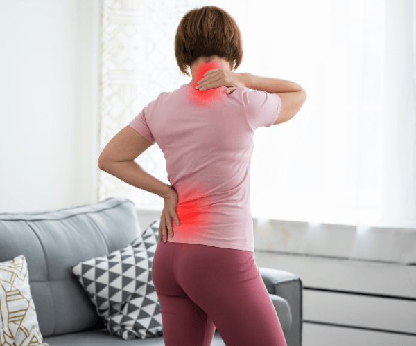 Woman with back pain holding her neck and back