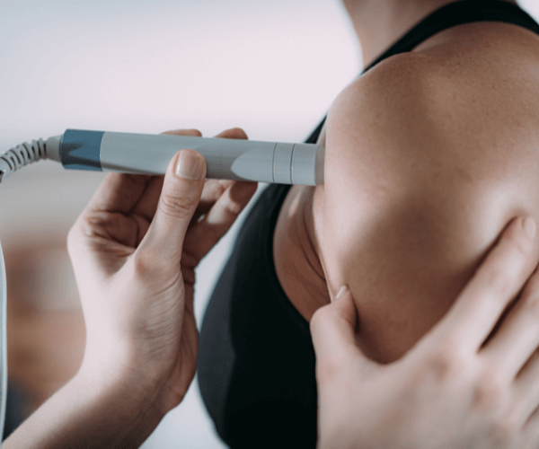 Laser Therapy. Physiotherapist treating patient's shoulder